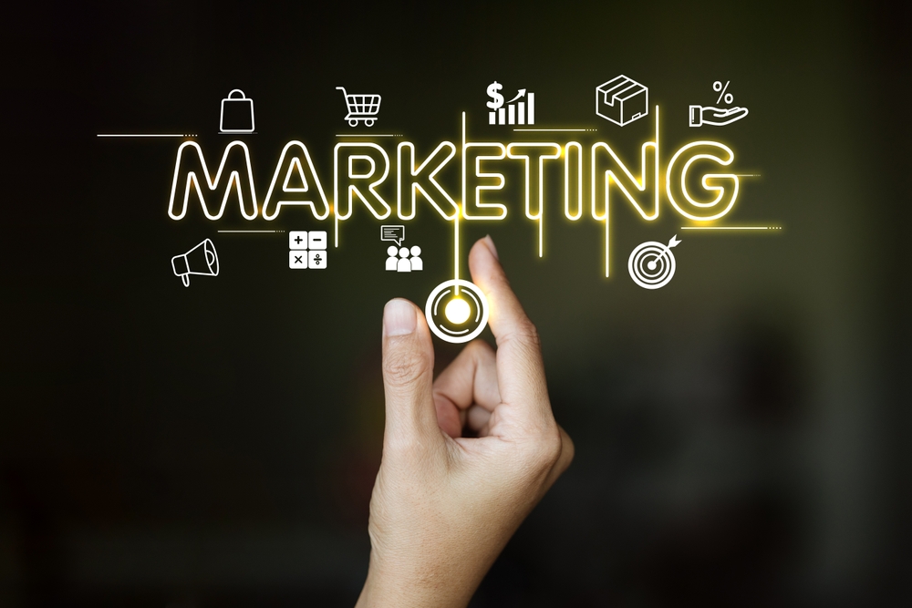 a,hand,is,pointing,to,the,word,"marketing",on,a